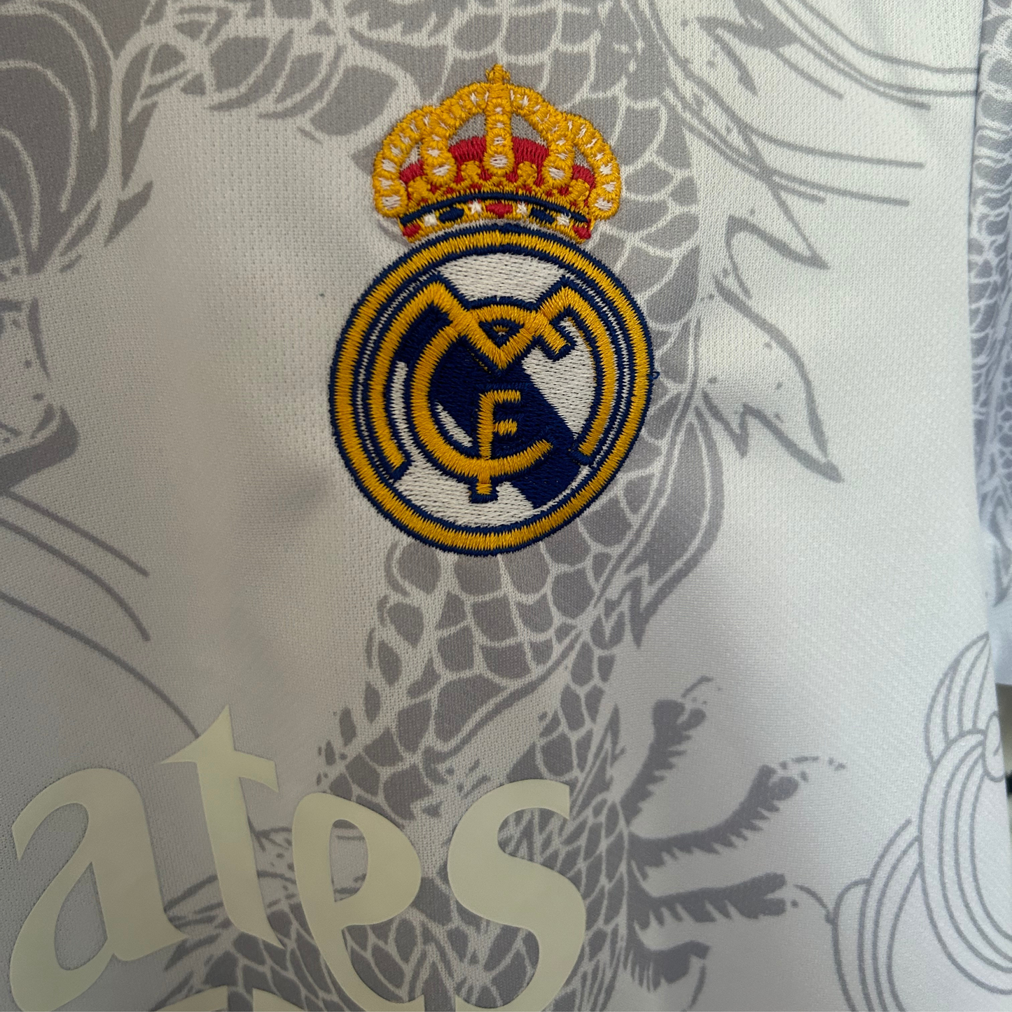 Real Madrid dragon white and black soccer kit by ELVN, featuring team logo, bold design, and athletic fit on a mannequin.