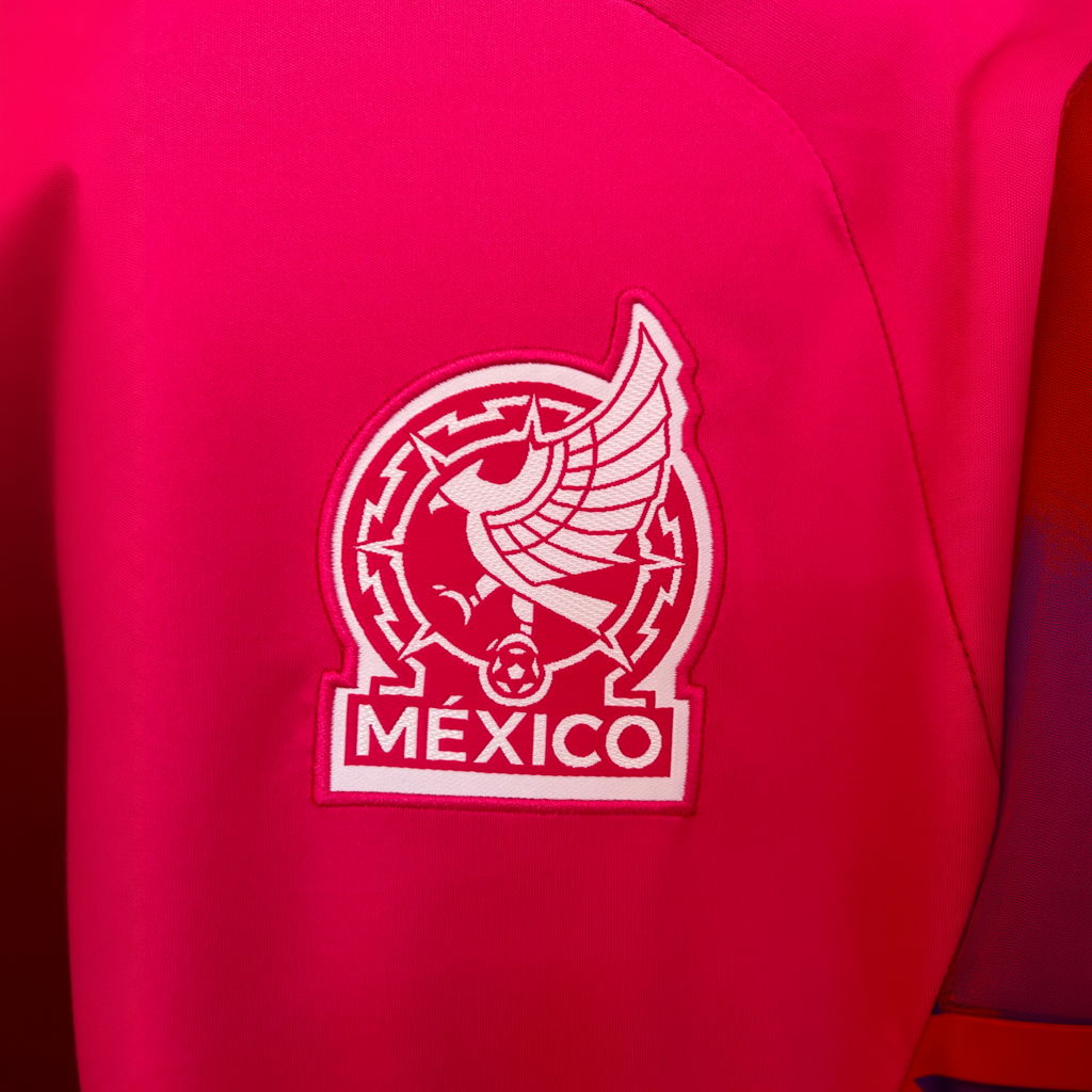 Mexico goalkeeper kit 2026 by ELVN featuring a green jersey, black shorts, and goalkeeper gloves on a sports field.
