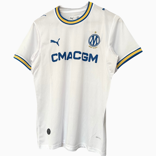 OLYMPIQUE MARSEILLE 2026/27 home kit by ELVN, featuring the team's jersey with club crest and team colors on a display.