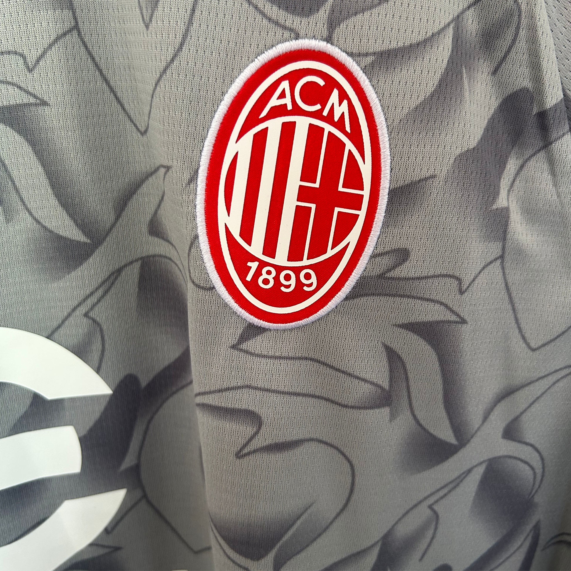 AC Milan pre-match kit 2025/26 by ELVN, featuring the team jersey with sponsor logos and team crest on the front.