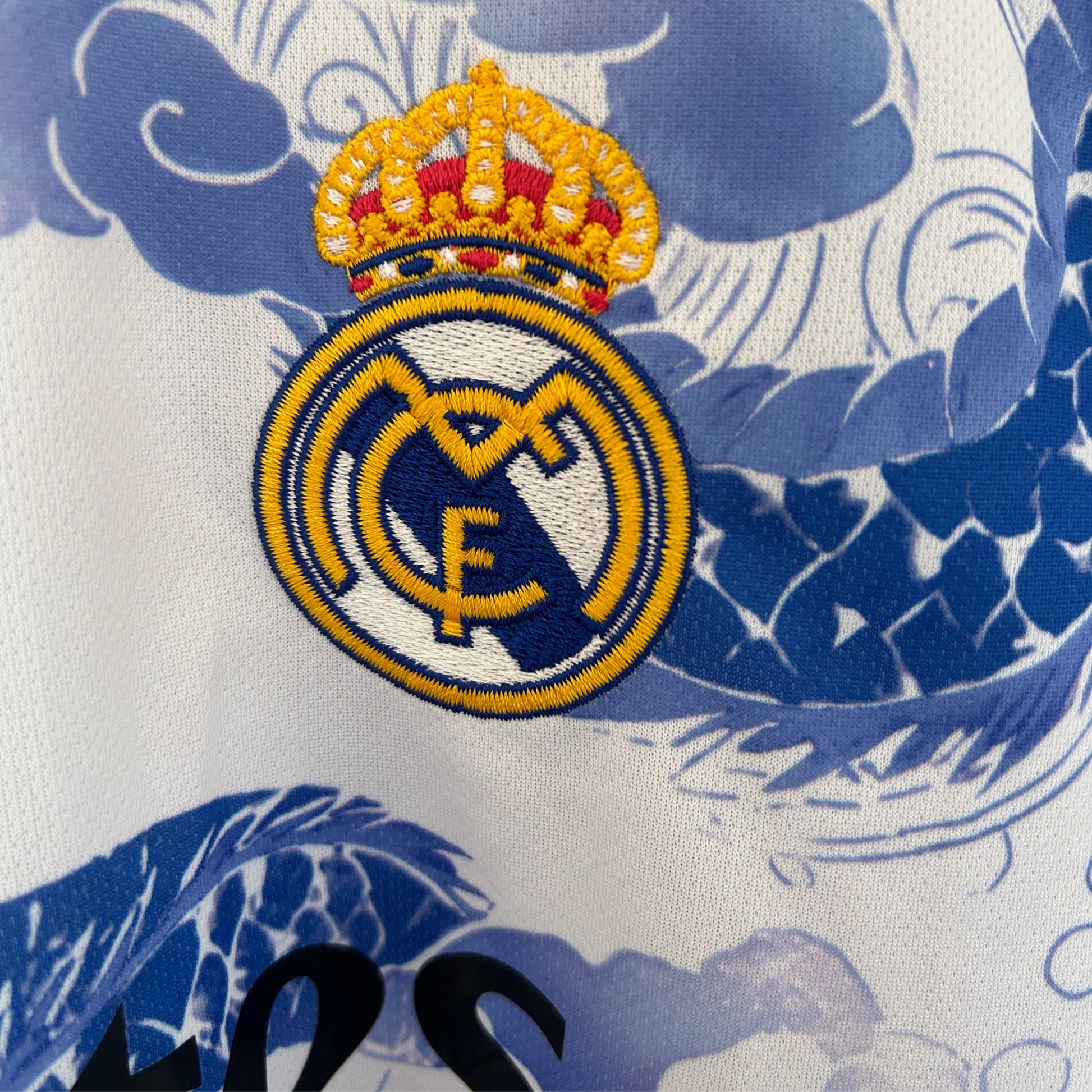 Real Madrid blue dragon kit by ELVN featuring the team crest, blue jersey, and dragon graphic design on the front.