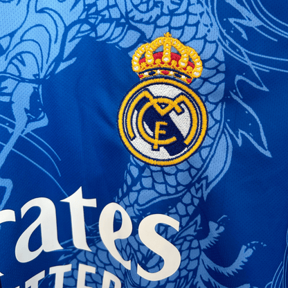 Real Madrid Dragon Blue Noir football kit by ELVN featuring the team logo and blue and black design elements.