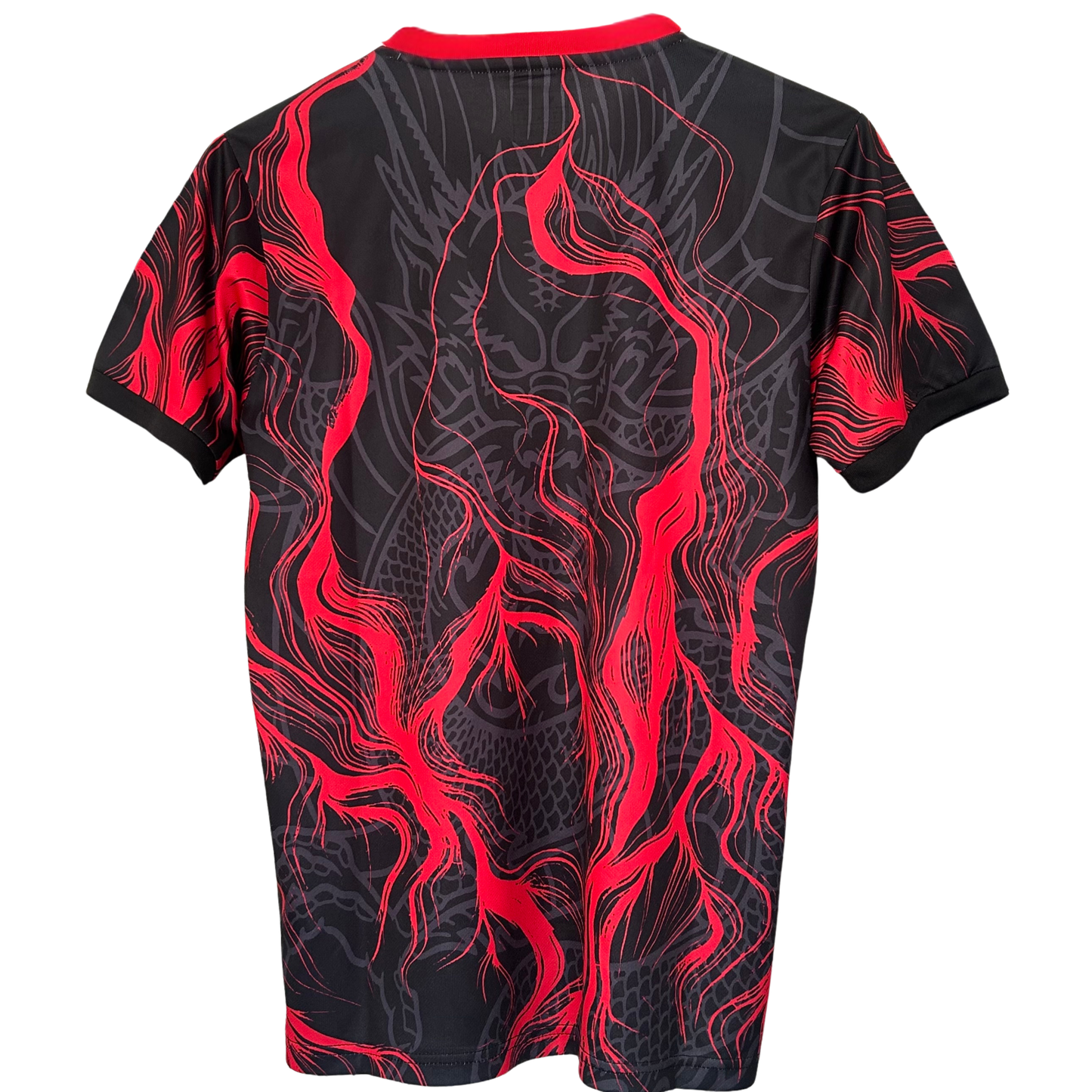 Red Real Madrid soccer kit by ELVN featuring the club's crest and dragon design, worn by a player on the field.
