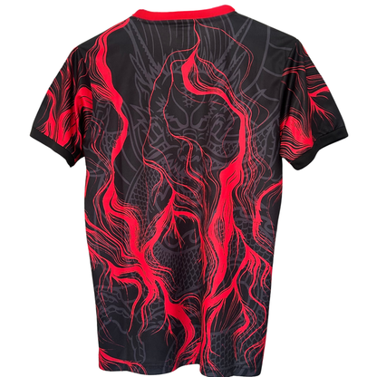 Red Real Madrid soccer kit by ELVN featuring the club's crest and dragon design, worn by a player on the field.