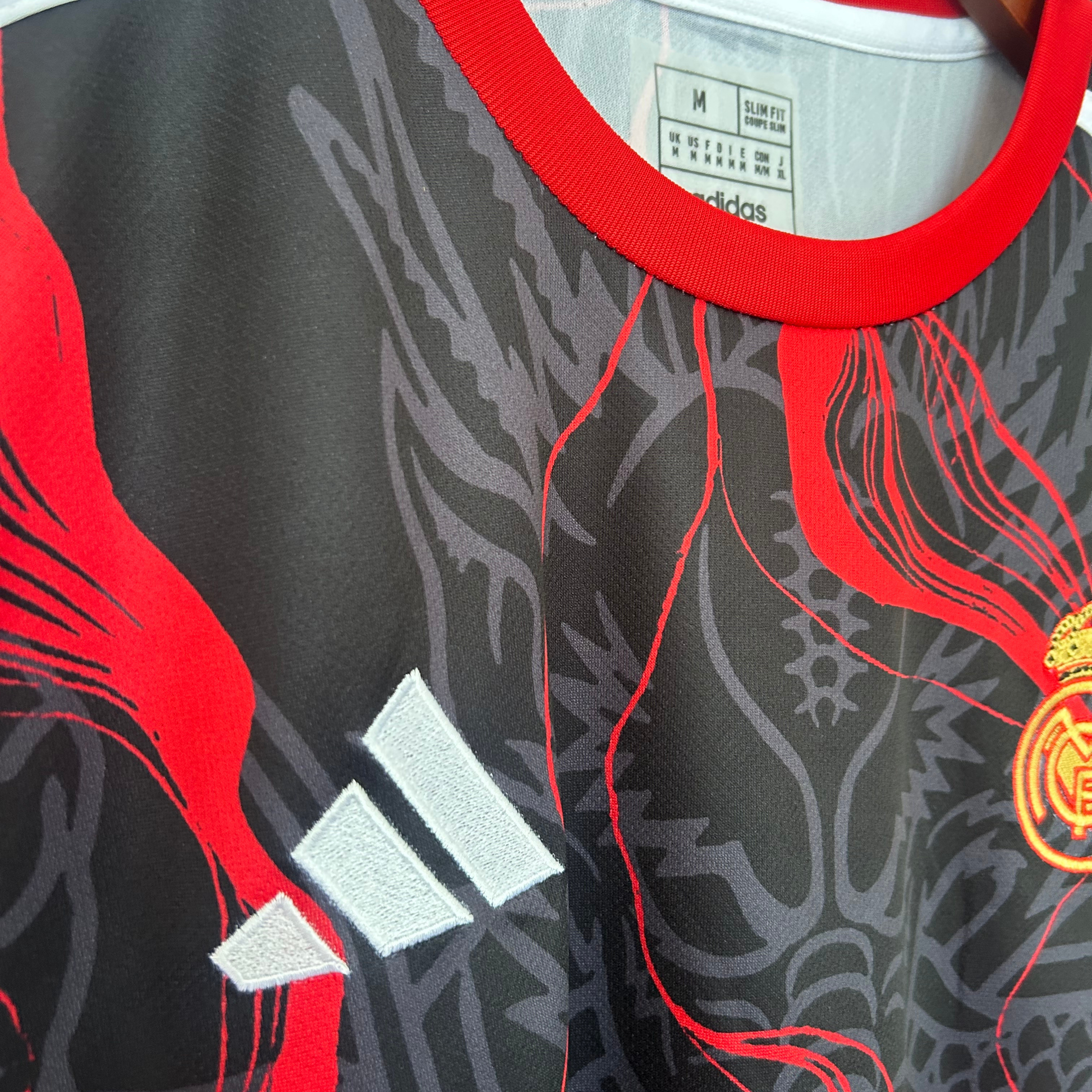 Real Madrid red dragon football kit by ELVN, featuring the team jersey with dragon design and team logo on the front.