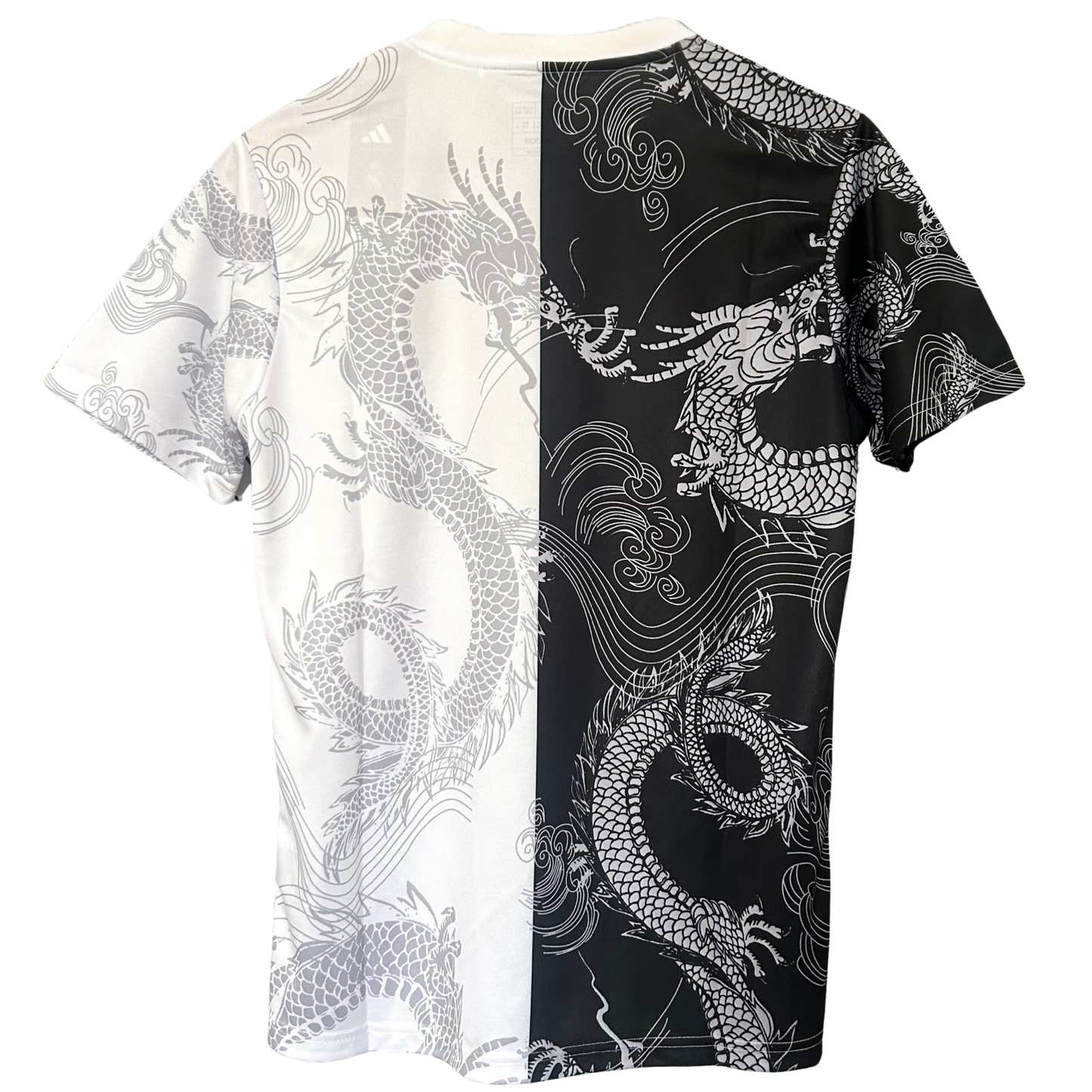 Real Madrid dragon white and black football kit by ELVN, featuring team crest and detailed design elements on jersey.