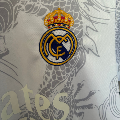 Real Madrid dragon white and black soccer kit by ELVN, featuring team logo, bold design, and athletic fit on a mannequin.