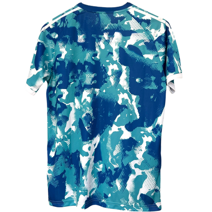 Real Madrid blue and white camouflage football kit by ELVN, featuring team logo and modern design.