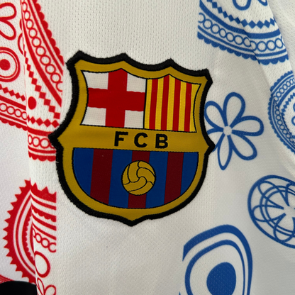 FC Barcelona paisley white kit by ELVN, featuring the team jersey with blue and claret accents and paisley pattern details.