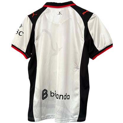 ELVN AC Milan x Slam Jam kit featuring a black and red jersey with matching shorts, displayed on a flat surface.