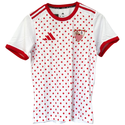 White Sevilla FC pre-match kit for 2025/26 by ELVN, featuring the team jersey with sponsor logos and team crest.
