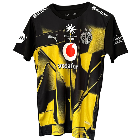 Elvn Borussia Dortmund graphic kit featuring the team's logo and vibrant yellow and black design, worn by a model.