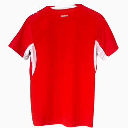 Switzerland home soccer kit 2026 by ELVN featuring the national team jersey, with red and white colors and team logos visible.