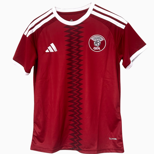 ELVN Qatar Home Kit 2026 soccer jersey featuring team logo and traditional maroon and white design, front view.