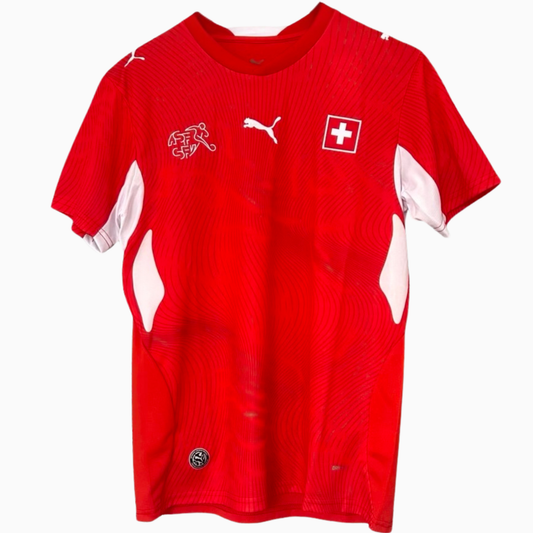 Switzerland home soccer kit 2026 by ELVN featuring the team jersey with Swiss flag and emblem, laid flat on a white background.