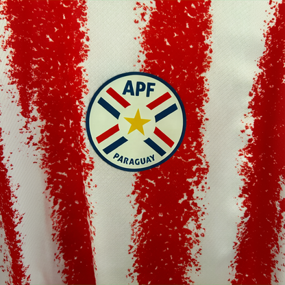 Elvn Paraguay home football kit 2026 with team jersey, shorts, and socks in red, white, and blue colors, displayed on a plain background.