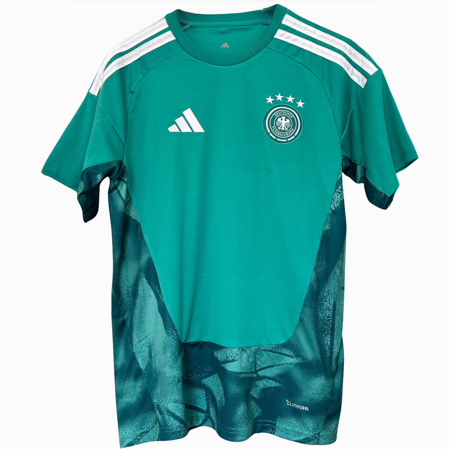Germany goalkeeper kit 2026 by ELVN featuring a green jersey, shorts, and goalkeeper gloves on a mannequin.