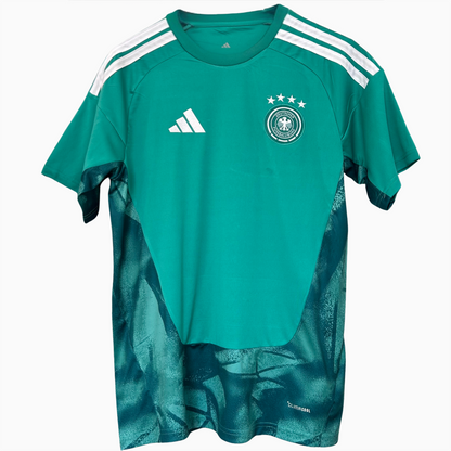 Germany goalkeeper kit 2026 by ELVN featuring a green jersey, shorts, and goalkeeper gloves on a mannequin.