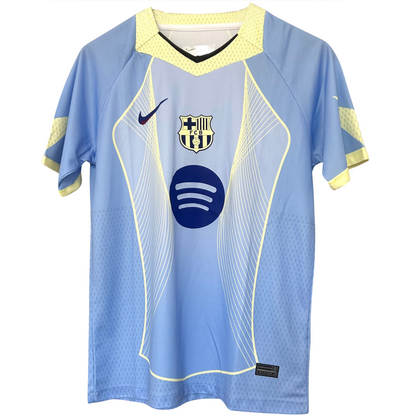 FC Barcelona light blue football kit by ELVN, featuring team crest and athletic design, worn by players on the field.