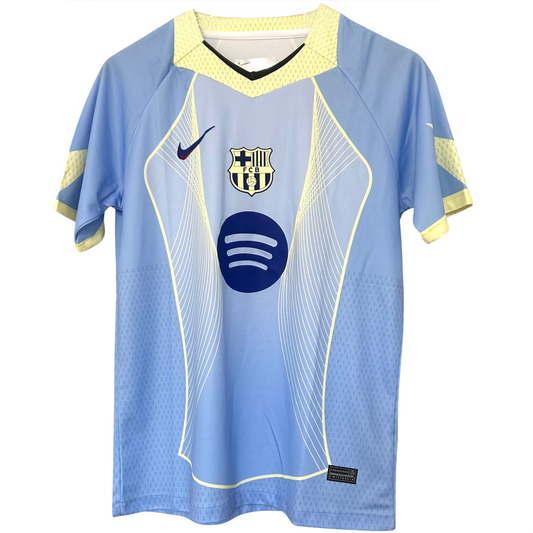 FC Barcelona light blue football kit by ELVN, featuring team crest and athletic design, worn by players on the field.