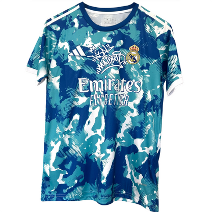 Real Madrid blue and white camouflage kit by ELVN, featuring the team jersey with distinctive camo pattern and team logo.